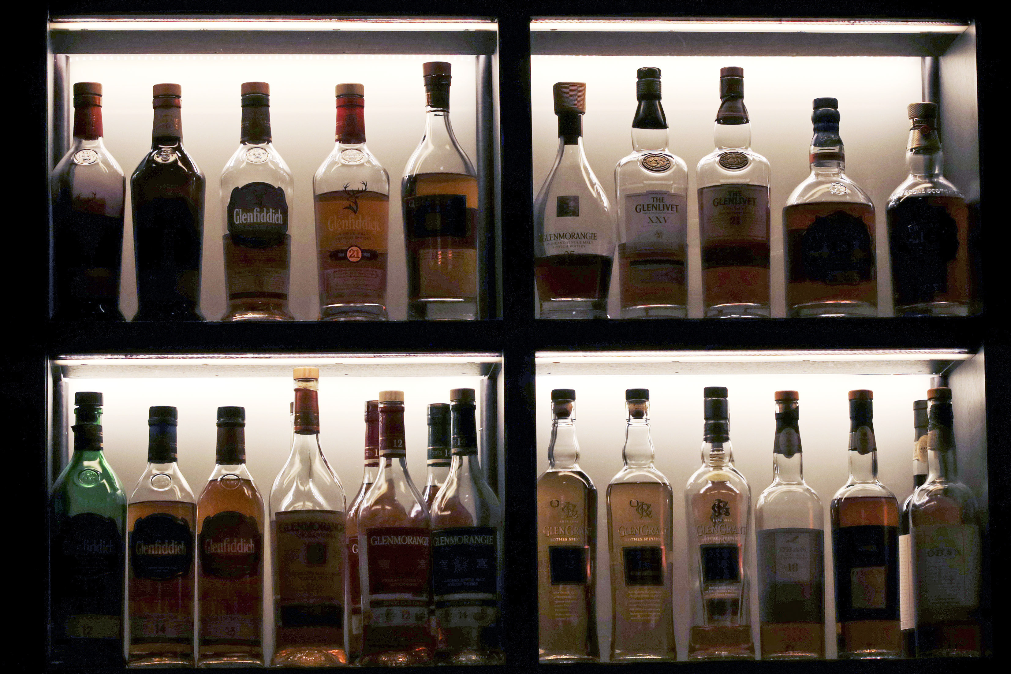 FILE - A vast array of single malt scotch bottles are displayed at Wink & Nod, basement-dwelling, speakeasy-like bar, in Boston, on Dec. 10, 2019. In Massachusetts, Democrats and Republicans could find an issue to agree on: letting bars have happy hours. Commonwealth law bans bars and other establishments from having special discounts on beer, wine and liquor. AP VoteCast shows a majority of voters favor the state legalizing happy hour. 