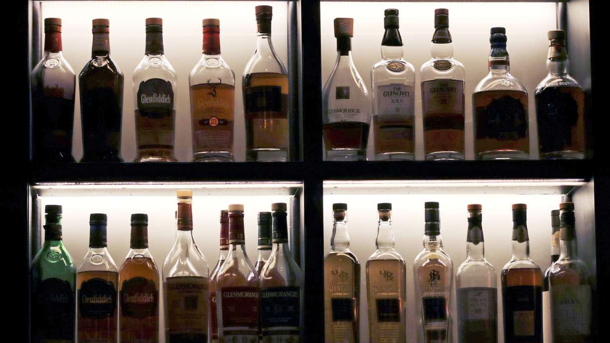 FILE - A vast array of single malt scotch bottles are displayed at Wink & Nod, basement-dwelling, speakeasy-like bar, in Boston, on Dec. 10, 2019. In Massachusetts, Democrats and Republicans could find an issue to agree on: letting bars have happy hours. Commonwealth law bans bars and other establishments from having special discounts on beer, wine and liquor. AP VoteCast shows a majority of voters favor the state legalizing happy hour.