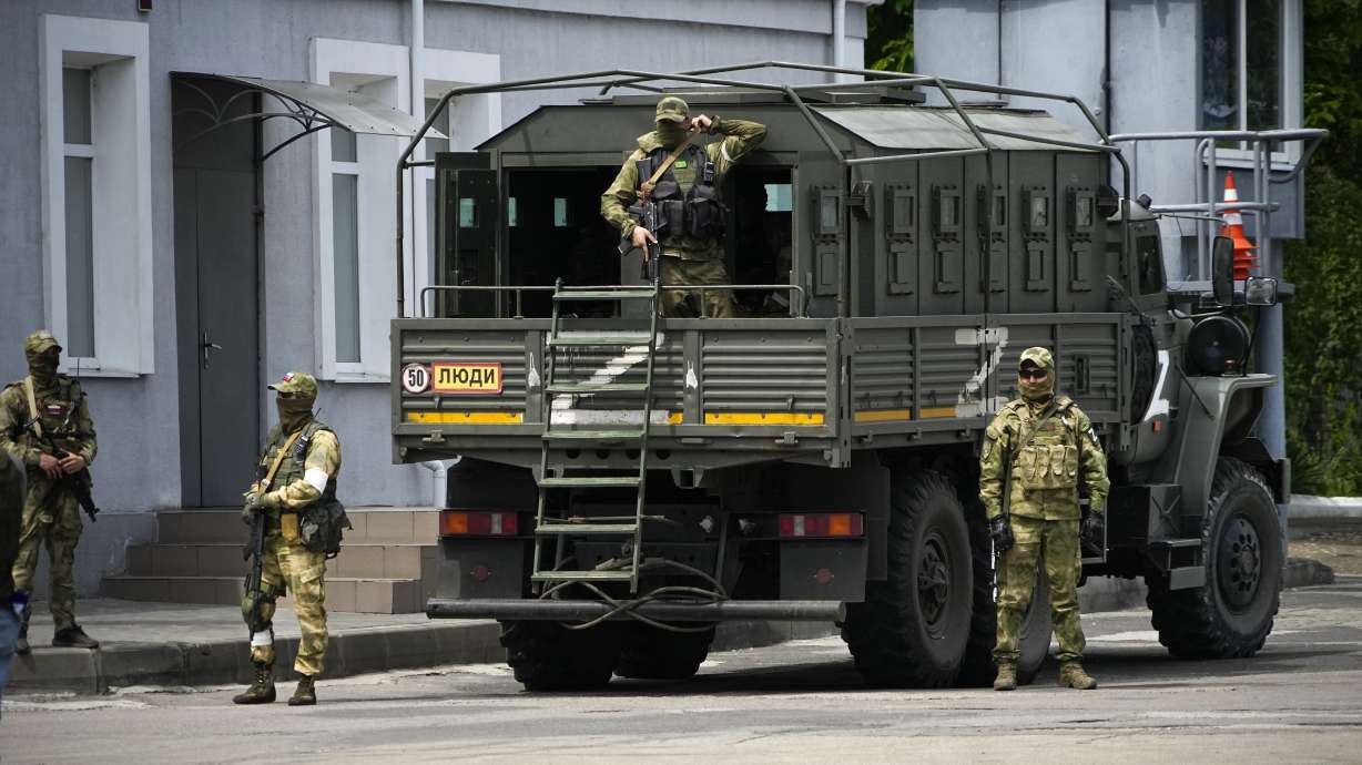 Russian soldiers guard an area as a group of foreign journalists visit in Kherson, Kherson region, south Ukraine, May 20. Russia’s military has announced that it’s withdrawing from Ukraine's southern city of Kherson and nearby areas.