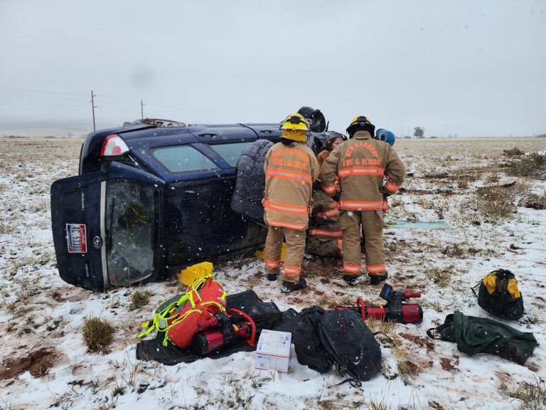 Emergency responders work to extricate the driver of a Subaru Forester following a rollover on I-15 in Iron County, Wednesday.
 