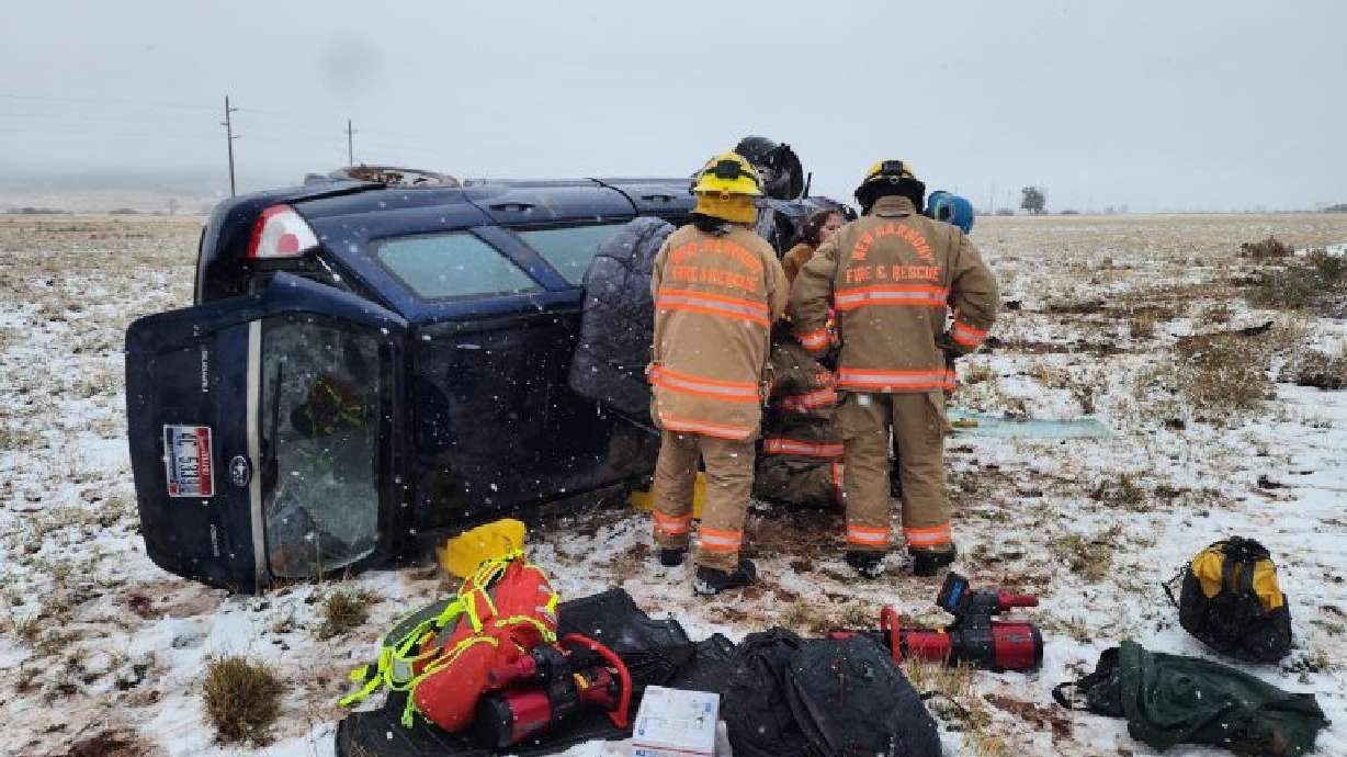 Emergency responders work to extricate the driver of a Subaru Forester following a rollover on I-15 in Iron County, Wednesday.