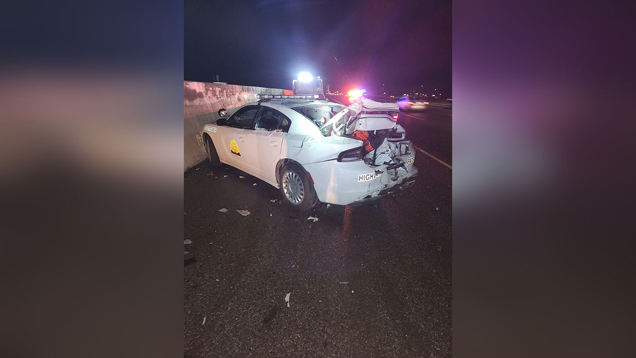 The vehicle of a Utah Highway Patrol trooper who was helping motorists who had slid off the freeway was heavily damaged early Thursday when another vehicle slid off the road and smashed into it.
