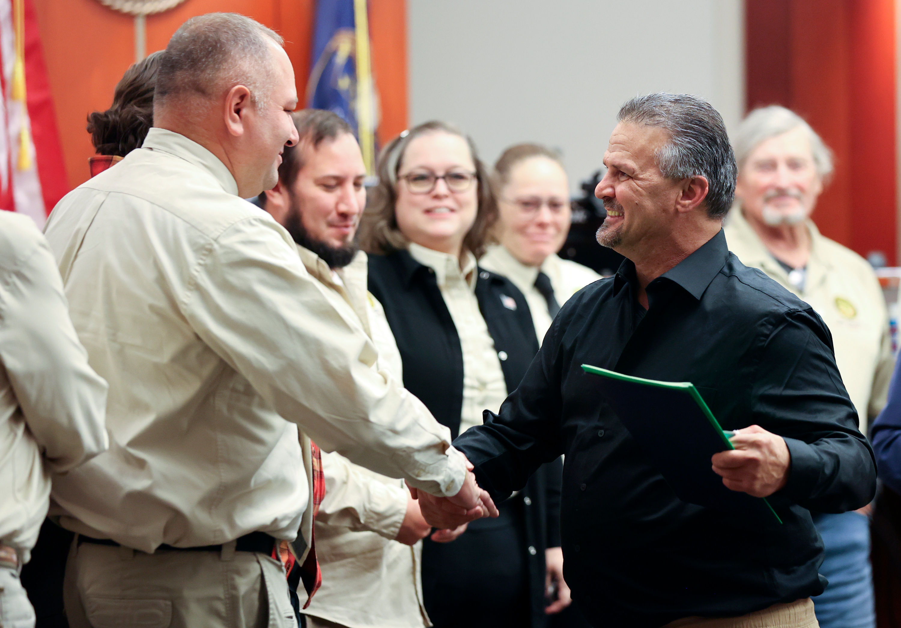 Al Palmer, Salt Lake County veterans treatment court mentor coordinator, shakes hands with Navy veteran Carl Costello during a veterans court graduation ceremony at the Matheson Courthouse in Salt Lake City on Thursday.