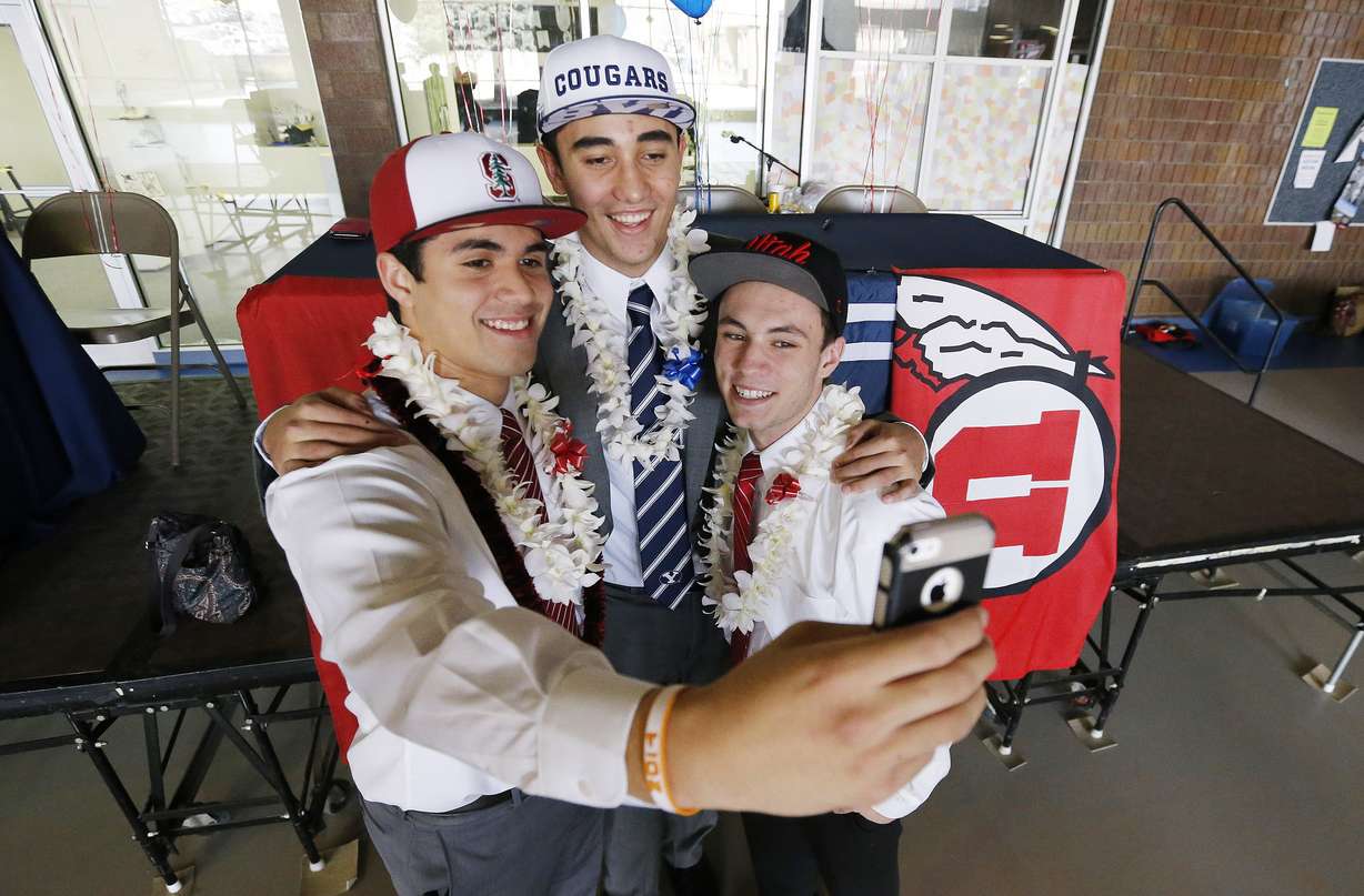 Timpview football players Gabe Reid, Devin Kaufusi and Britain Covey take a photo as they sign their Letters of Intent in Provo Wednesday, Feb. 4, 2015.