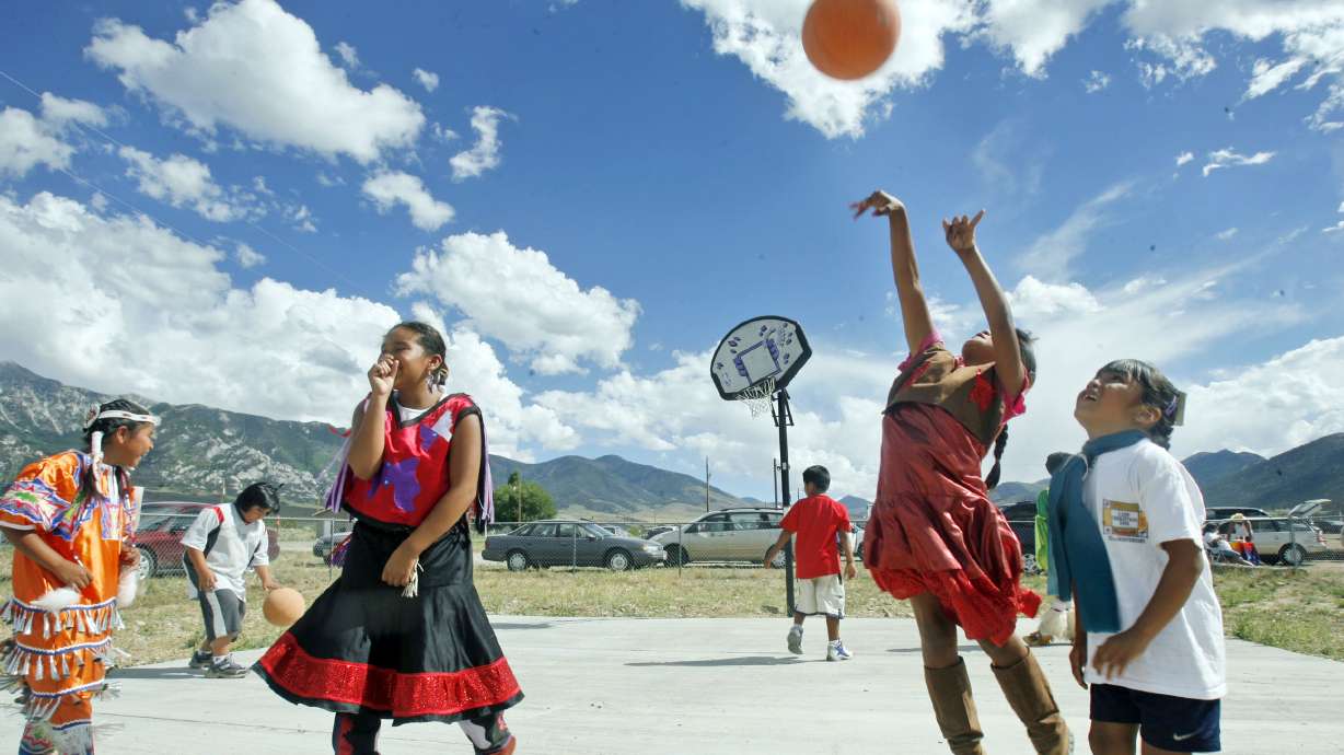 Children play basketball during a lunch break at the Goshute Pow Wow on the Confederated Tribes of the Goshute Reservation in Ibapah, Utah, on Aug. 5, 2006. The Supreme Court is listening to a challenge to the 1978 Indian Child Welfare Act.