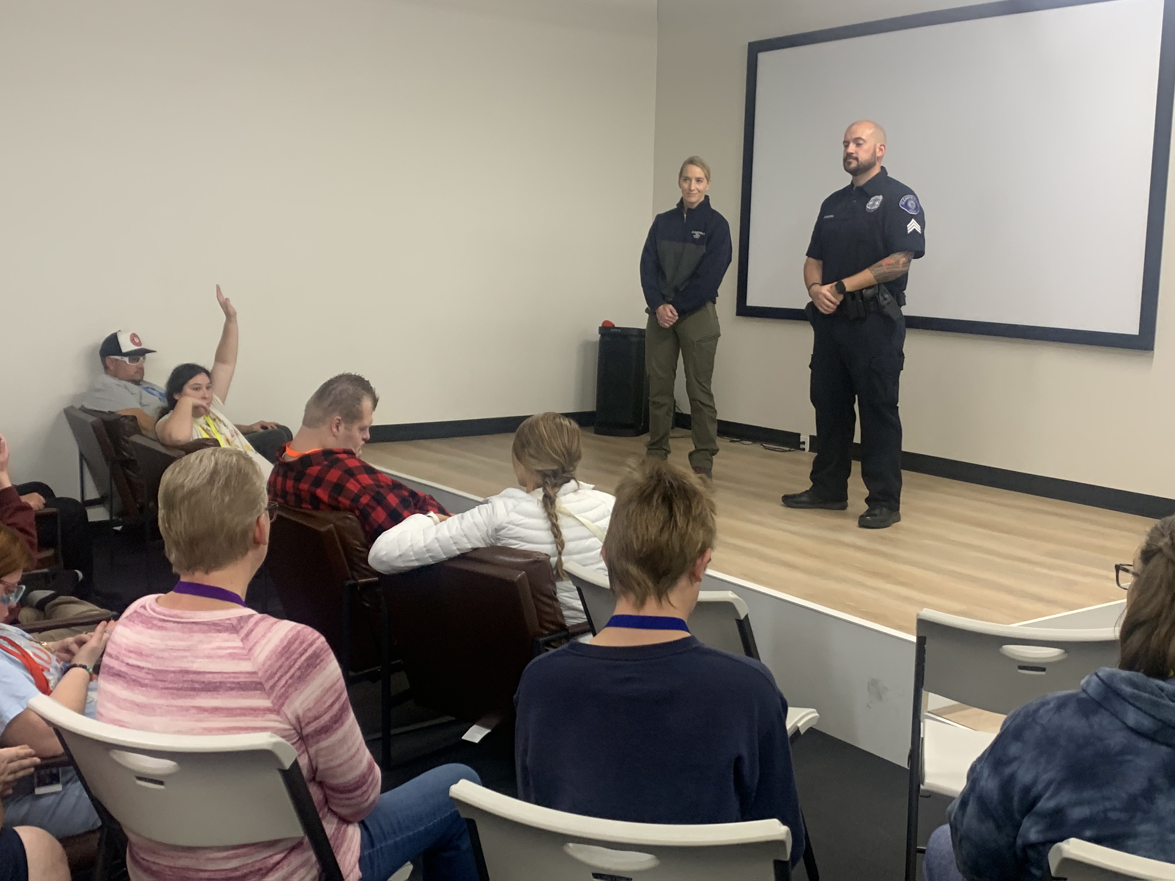 Clearfield police detective Heather Arnell, left, and Sgt. Chris Fererra speak to clients of Buddies4Life, a resource center for people with disabilities in Clearfield, on Thursday.