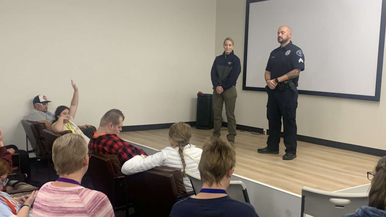 Clearfield police detective Heather Arnell, left, and Sgt. Chris Fererra speak to clients of Buddies4Life, a resource center for people with disabilities in Clearfield, on Thursday.