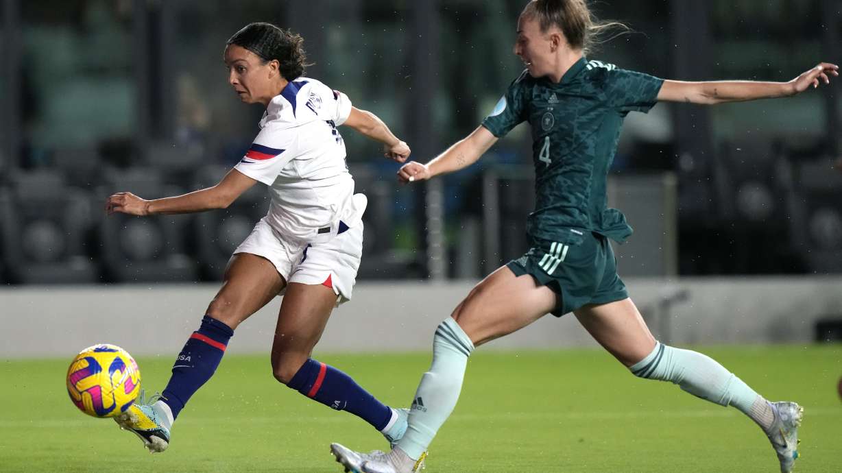 U.S. forward Mallory Pugh, left, attempts a shot on the goal as Germany defender Sophia Kleinherne (4) defends during the first half of an international friendly soccer match, Thursday, Nov. 10, 2022, in Fort Lauderdale, Fla.