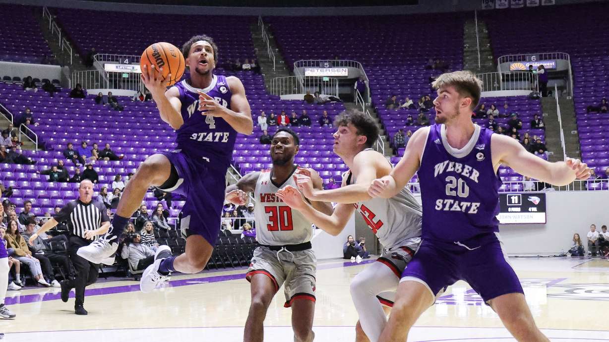 Weber State guard Junior Ballard (4) drives to the hoop while center Alex Tew (20) boxes out a defender in a game against Western Colorado on Nov. 10, 2022.