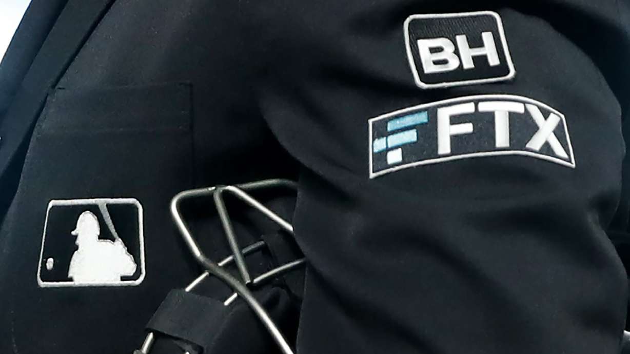 File - The FTX logo appears on home plate umpire Jansen Visconti's jacket at a baseball game with the Minnesota Twins on Tuesday, Sept. 27, 2022, in Minneapolis. Embattled cryptocurrency exchange FTX, short billions of dollars, is seeking bankruptcy protection, Friday, Nov. 11, following its collapse this week.