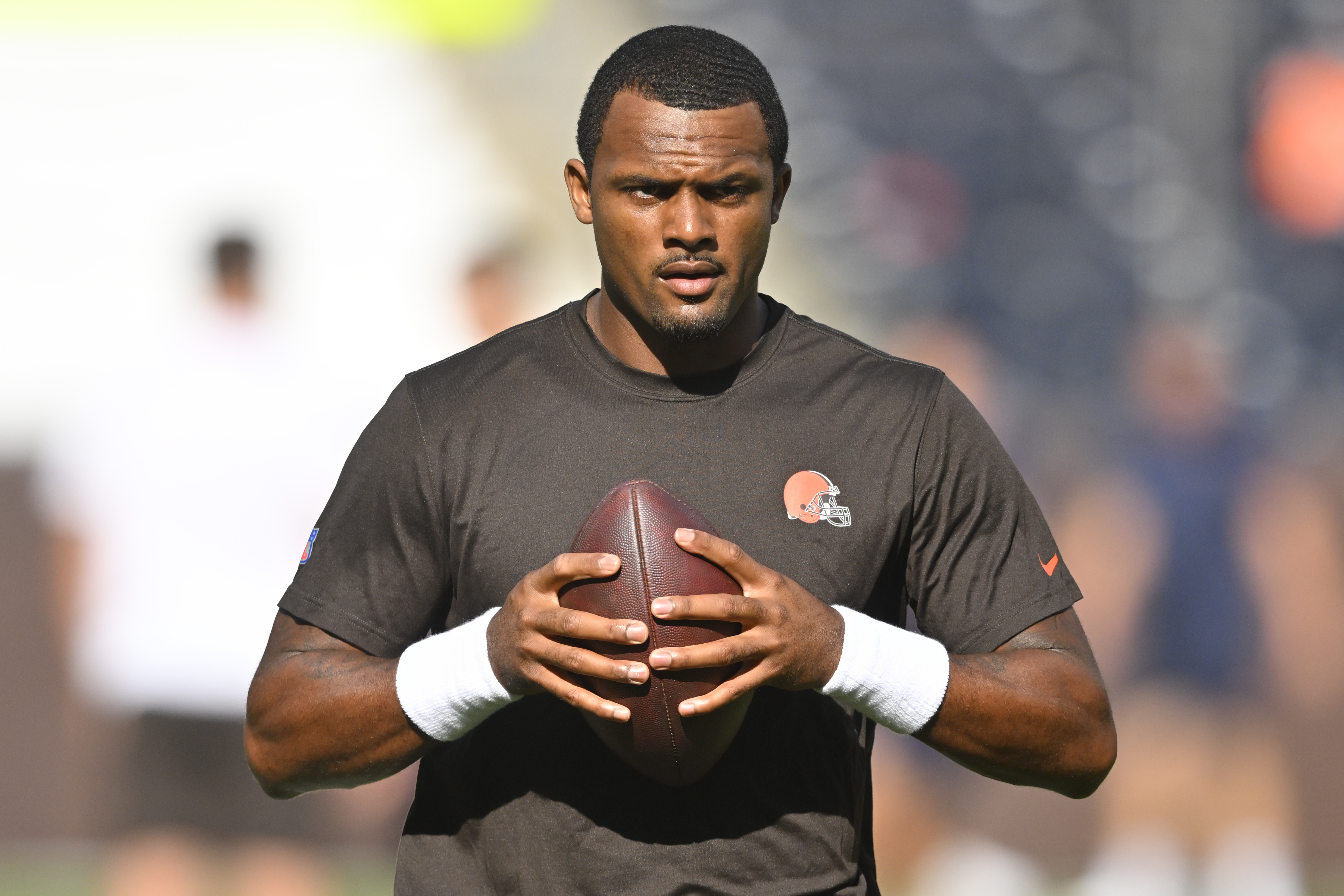 FILE - Cleveland Browns quarterback Deshaun Watson stands on the field before an NFL preseason football game against the Chicago Bears, on Aug. 27, 2022, in Cleveland. Watson can begin practicing on Monday, Nov. 14, 2022,  as part of his agreement with the NFL on an 11-game suspension after being accused of sexual misconduct by two dozen women when he played for Houston. 