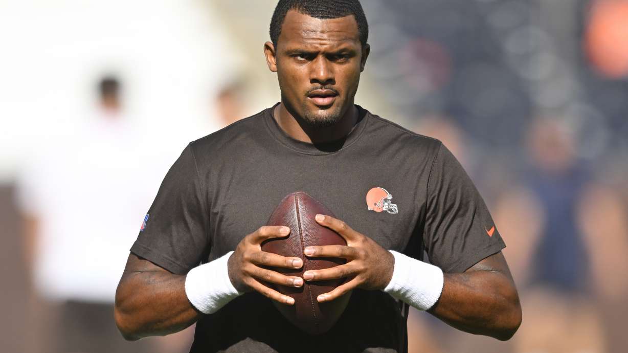 FILE - Cleveland Browns quarterback Deshaun Watson stands on the field before an NFL preseason football game against the Chicago Bears, on Aug. 27, 2022, in Cleveland. Watson can begin practicing on Monday, Nov. 14, 2022, as part of his agreement with the NFL on an 11-game suspension after being accused of sexual misconduct by two dozen women when he played for Houston.