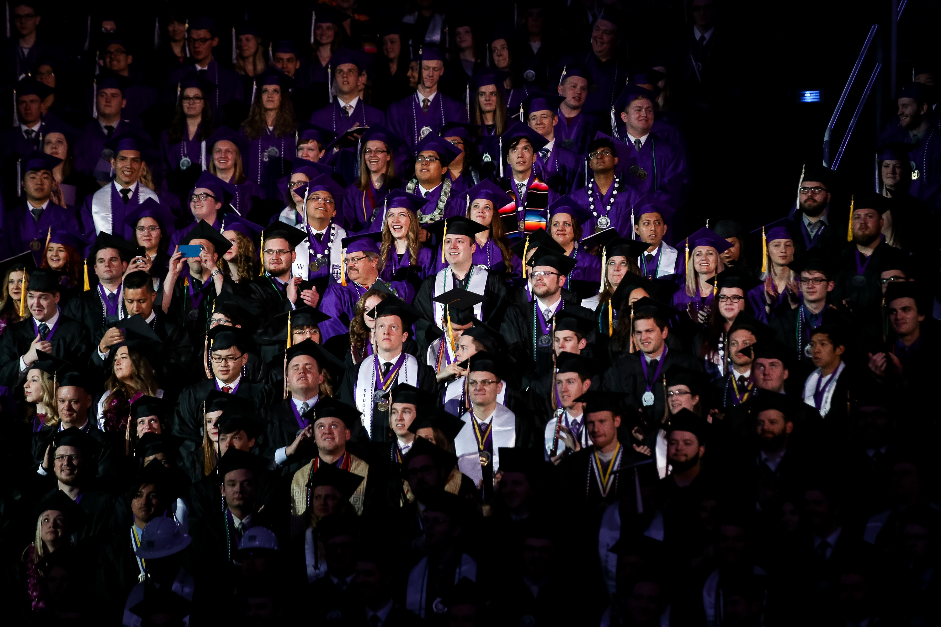 Graduate candidates stand during Weber State University’s commencement in Ogden on April 26, 2019. The university is one of a growing number of higher education institutions in the state pushing to increase Hispanic enrollment.