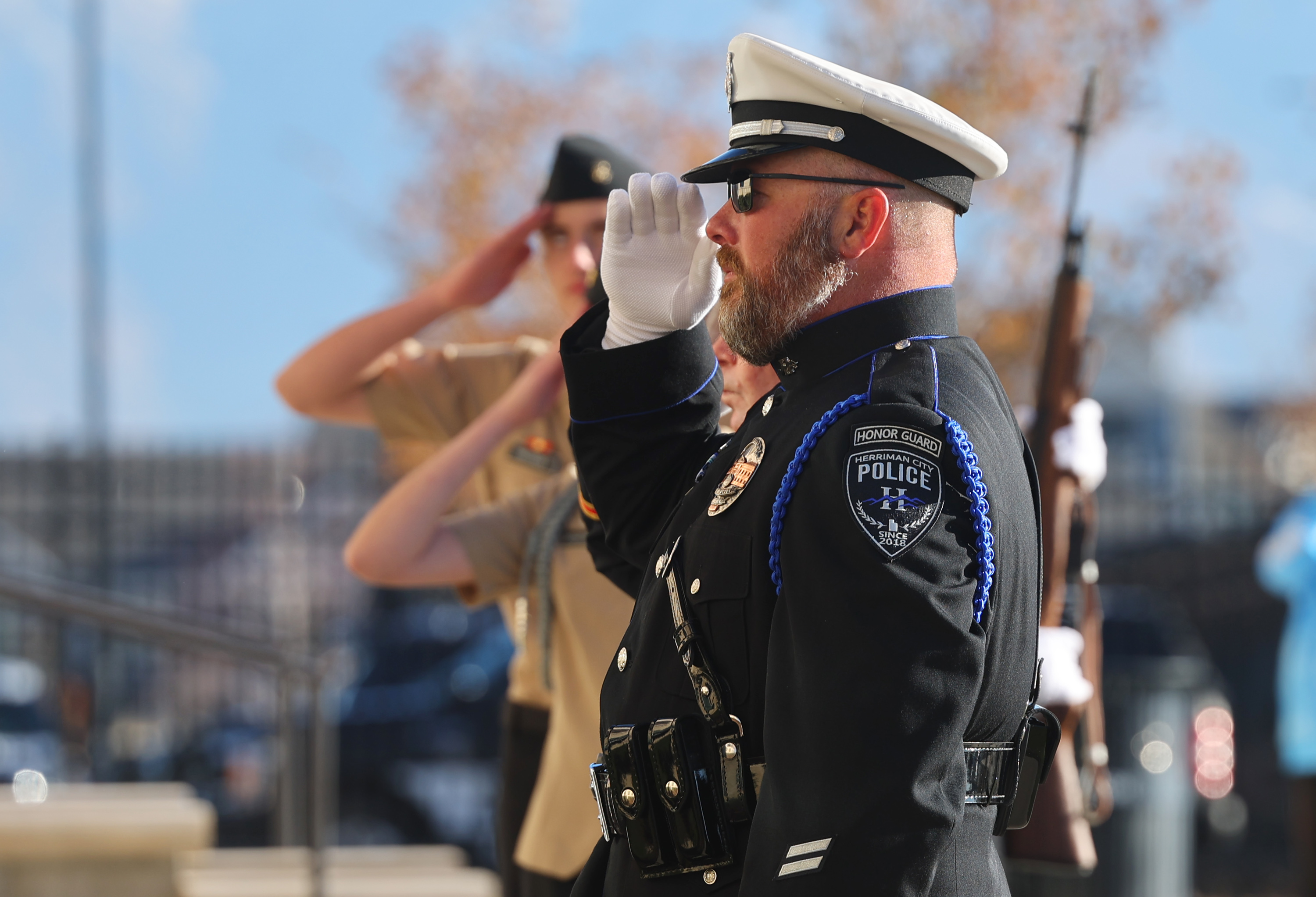 Members of the Herriman Police Department, junior ROTC and Veterans and Military Advisory Committee salute during a Veterans Day flag ceremony at Herriman City Hall on Friday. Veterans Day ceremonies were held across Utah on Friday.
