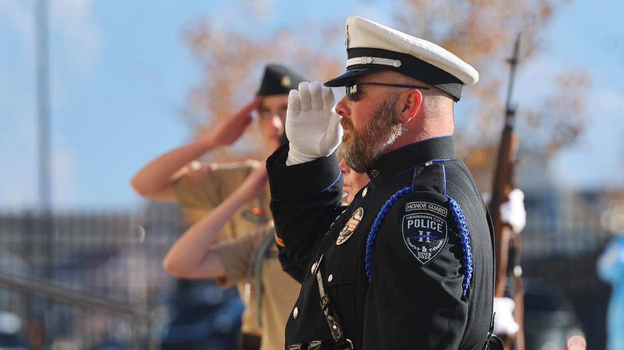 Members of the Herriman Police Department, junior ROTC and Veterans and Military Advisory Committee salute during a Veterans Day flag ceremony at Herriman City Hall on Friday. Veterans Day ceremonies were held across Utah on Friday.