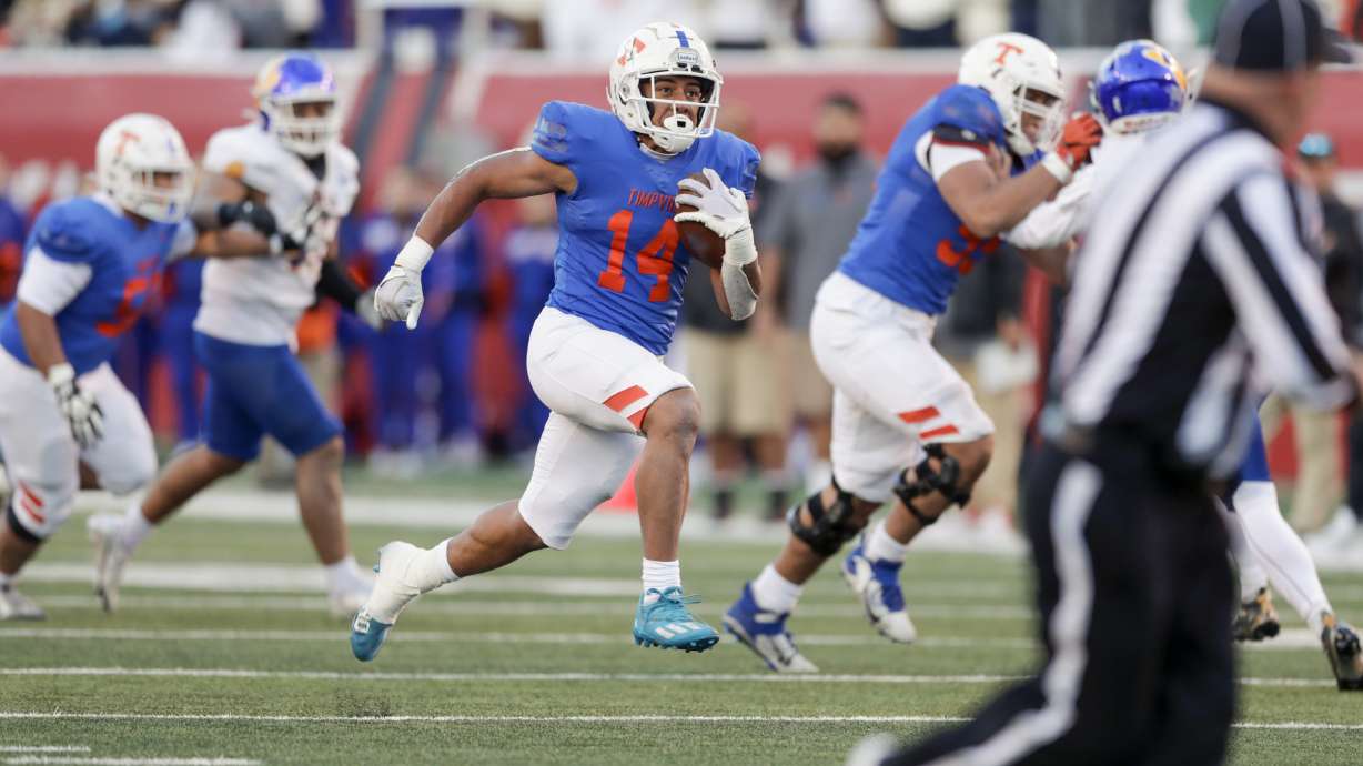 Timpview Thunderbirds Micah Becksteadm (14) runs the ball while playing the Orem Tigers in the 5A semi finals at Rice-Eccles Stadium in Salt Lake City on Friday, Nov. 11, 2022. The Thunderbirds won 48-31.