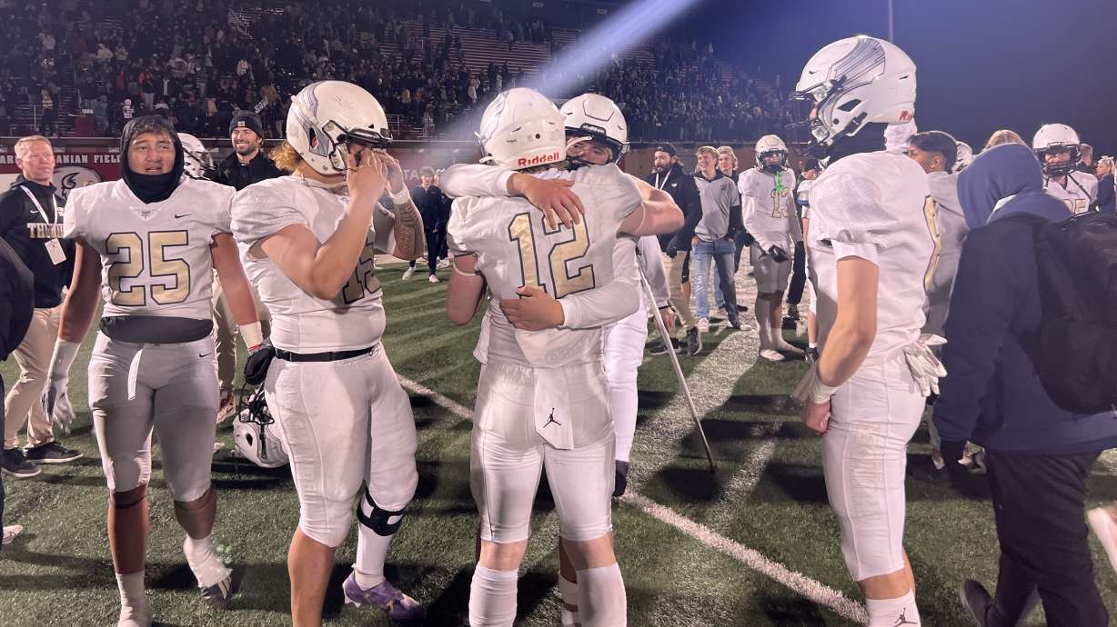 Desert Hills players embrace after the 4A championship game Friday.