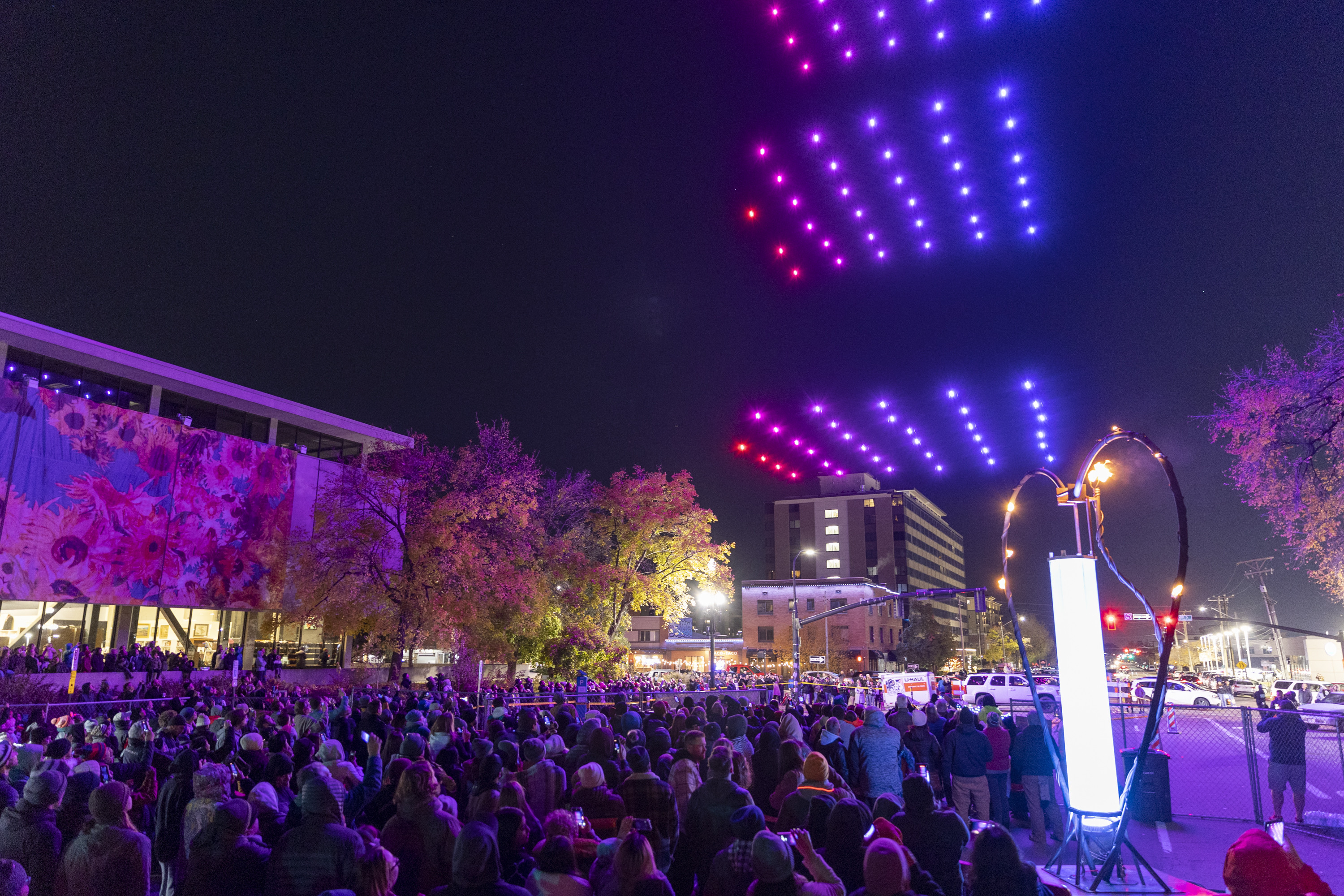 Attendees watch as 150 drones perform over them at ILLUMINATE: Light Art + Creative Tech Fest in Salt Lake City on Friday.