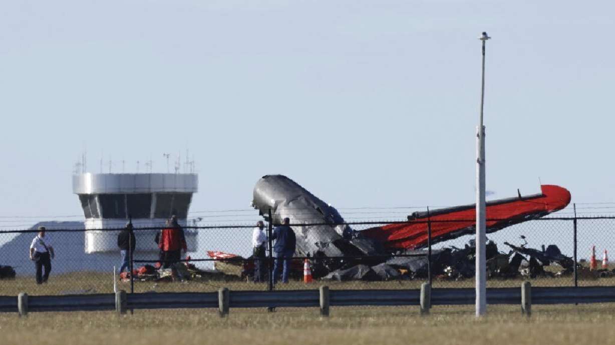 A damaged plane sits at the Dallas Executive Airport in Dallas, Texas, after two historic military planes collided and fell to the ground on Saturday.