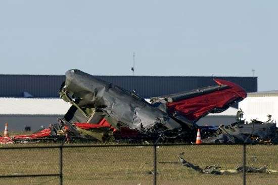 Debris from two planes that crashed during an airshow at Dallas Executive Airport are shown in Dallas on Saturday.