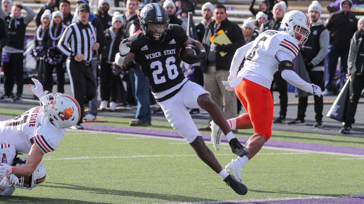 Weber State running back Damon Bankston (26) dances into the end zone for a score in a game the Wildcats won against Idaho State 45-7 on Nov. 12, 2022.