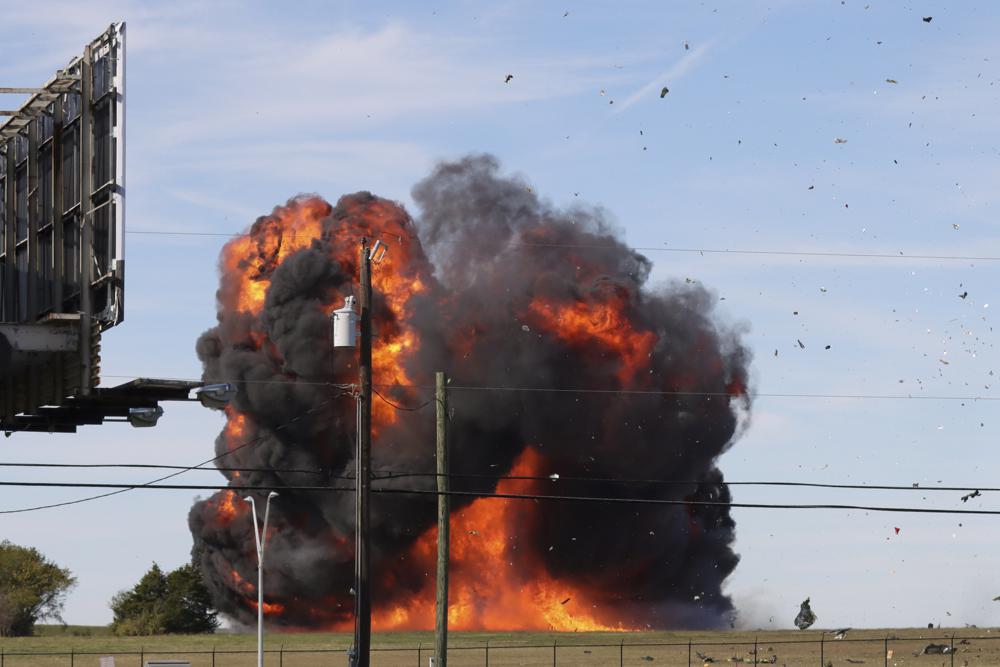 A historic military plane crashes after colliding with another plane during an airshow at Dallas Executive Airport in Dallas on Saturday.