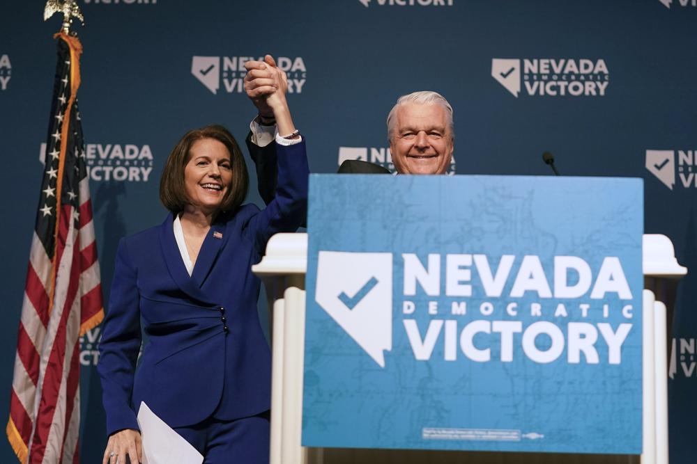 Sen. Catherine Cortez Masto, D-Nev., left, reacts alongside Nevada Gov. Steve Sisolak during an election night party hosted by the Nevada Democratic Party, Tuesday in Las Vegas. 