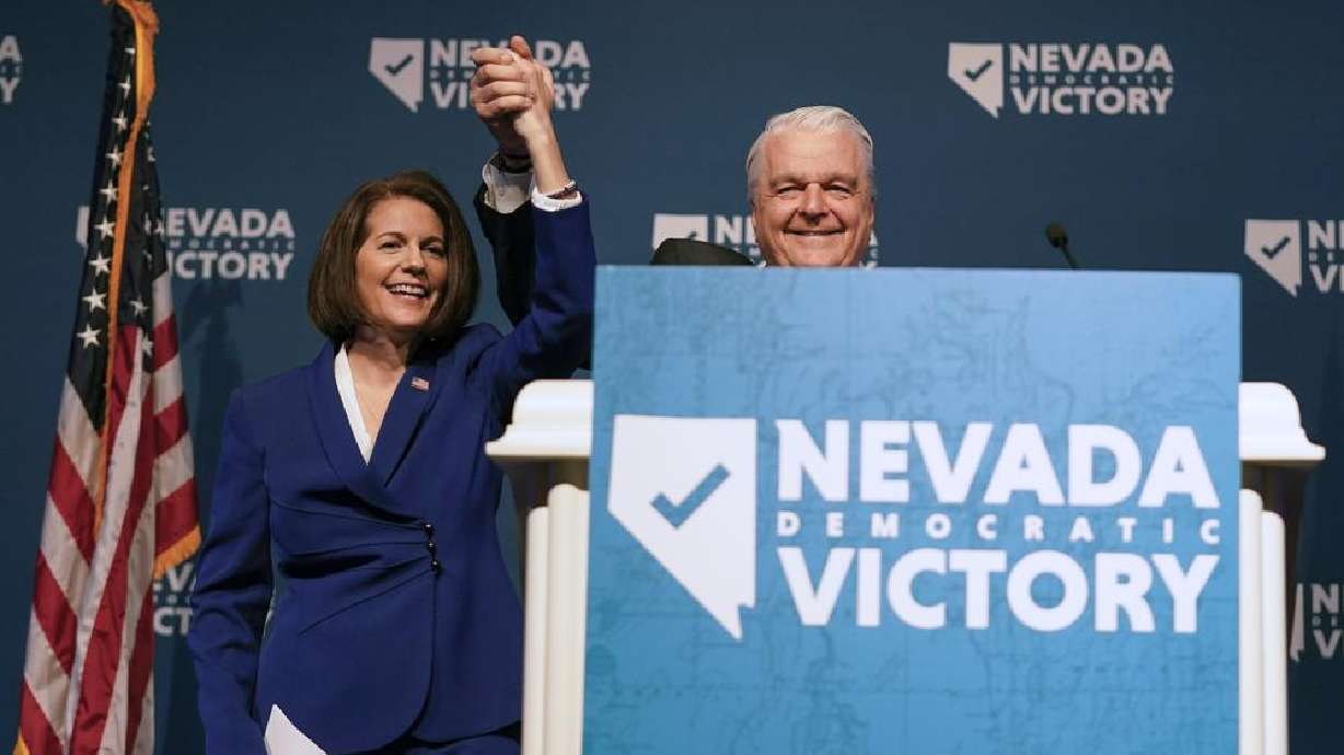 Sen. Catherine Cortez Masto, D-Nev., left, reacts alongside Nevada Gov. Steve Sisolak during an election night party hosted by the Nevada Democratic Party, Tuesday in Las Vegas.