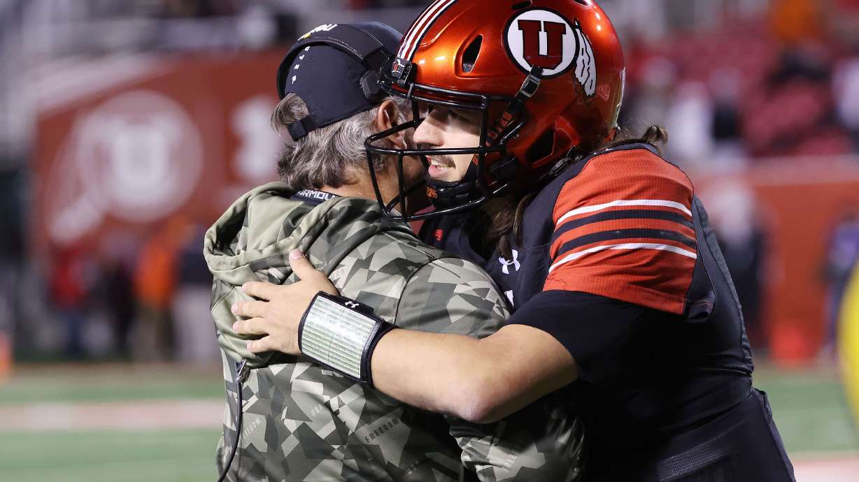 Utah Utes quarterback Cameron Rising (7) hugs Utah Utes head coach Kyle Whittingham at the end of the game against Stanford Cardinal in Salt Lake City on Saturday, Nov. 12, 2022.