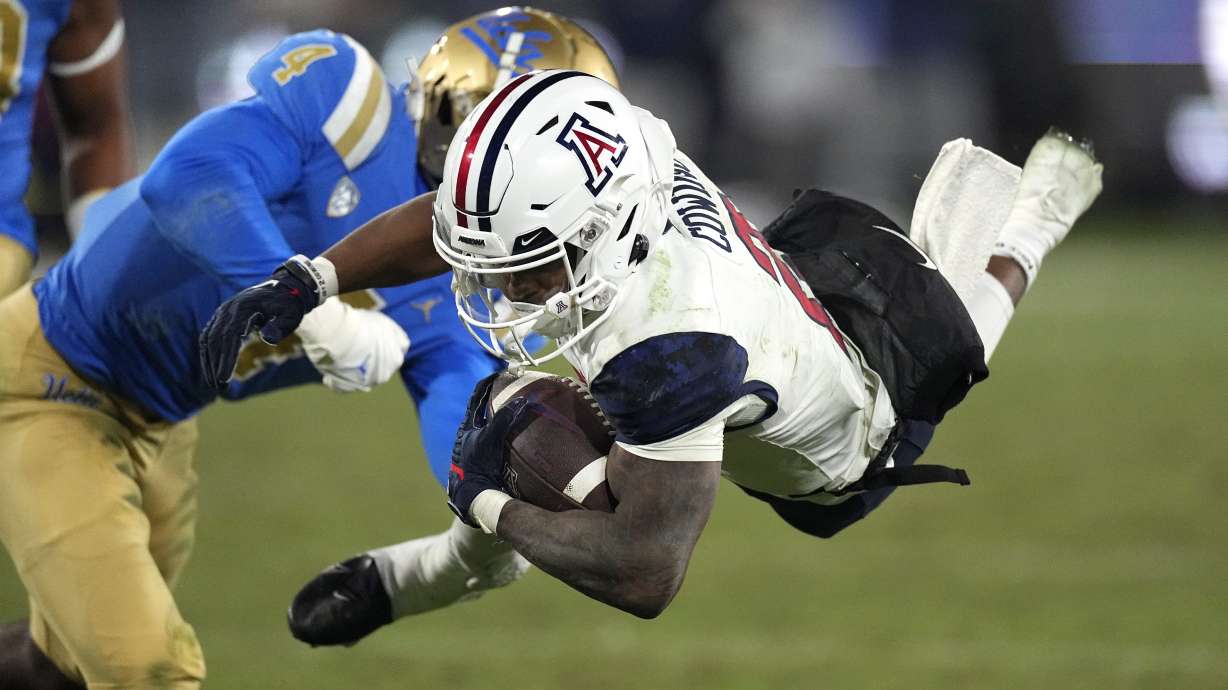 Arizona wide receiver Jacob Cowing, right, is tackled by UCLA defensive back Stephan Blaylock during the second half of an NCAA college football game Saturday, Nov. 12, 2022, in Pasadena, Calif.