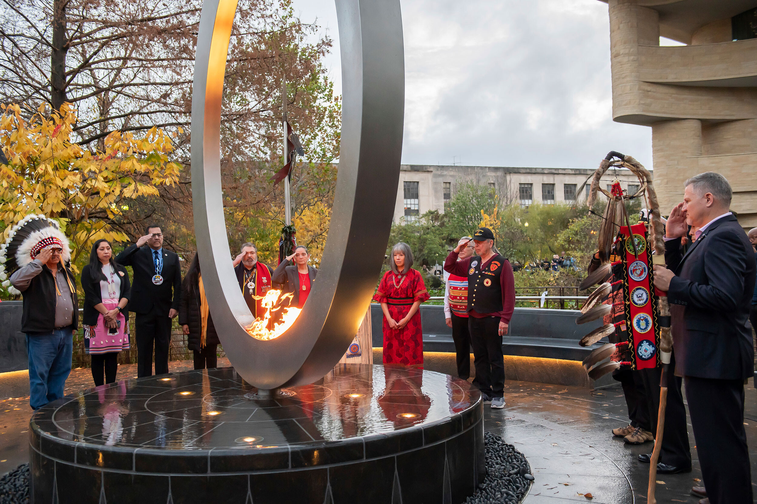 Cynthia Chavez Lamar, director of the Smithsonian's National Museum of the American Indian, left, and designer Harvey Pratt of the Cheyenne and Arapaho tribes of Oklahoma, right, in front of the National Native American Veterans Memorial on Friday in Washington, D.C.