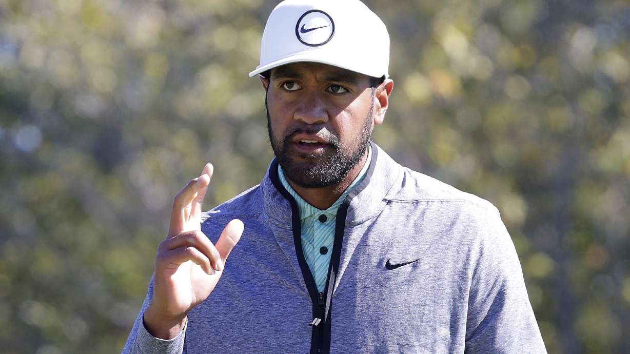 Tony Finau waves to the gallery as they cheer his birdie on the ninth hole during the final round of the Houston Open golf tournament Sunday, Nov. 13, 2022, in Houston.