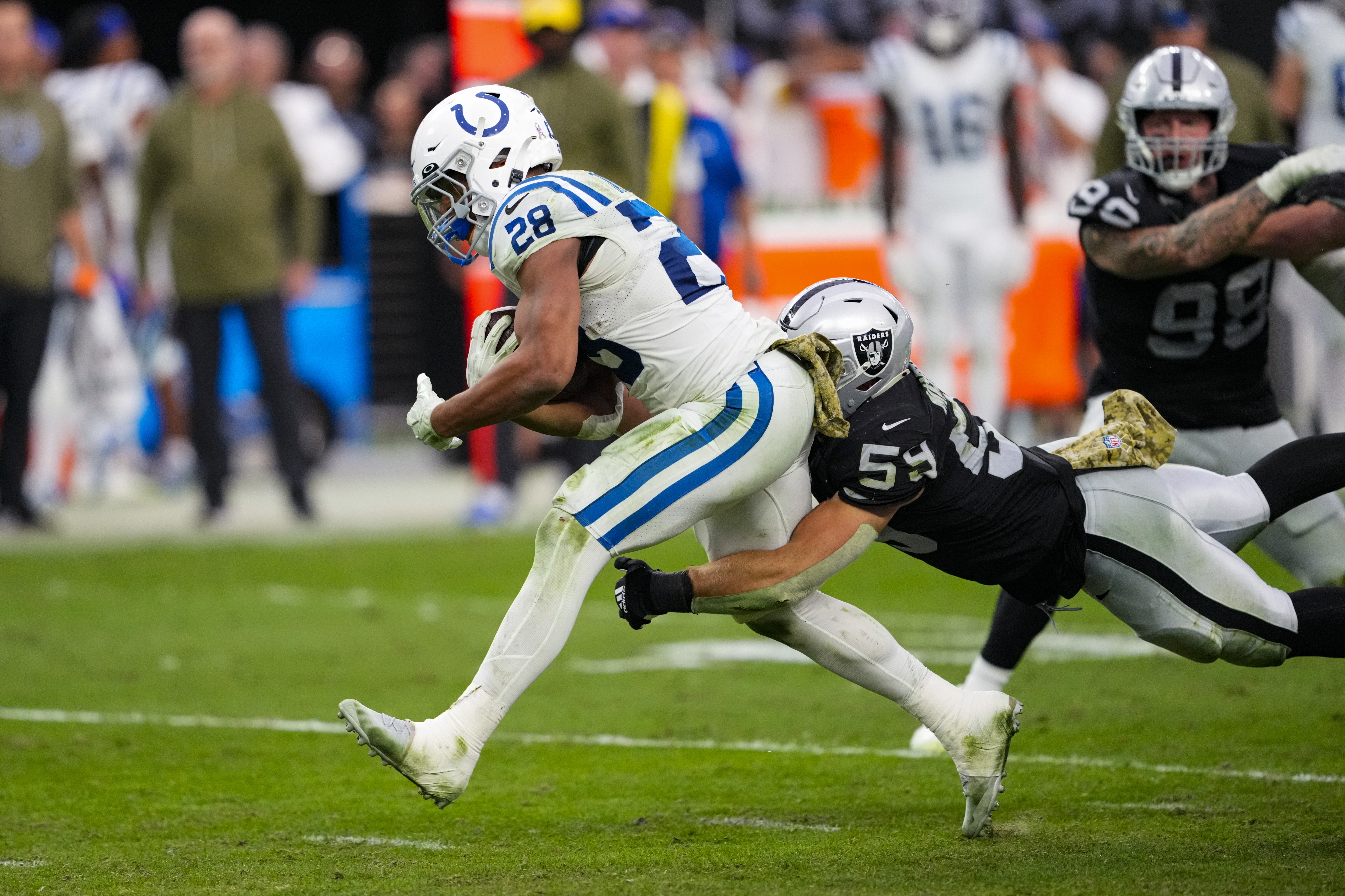 Indianapolis Colts running back Jonathan Taylor (28) is tackled by Las Vegas Raiders linebacker Luke Masterson (59) in the first half of an NFL football game in Las Vegas, Sunday, Nov. 13, 2022. 
