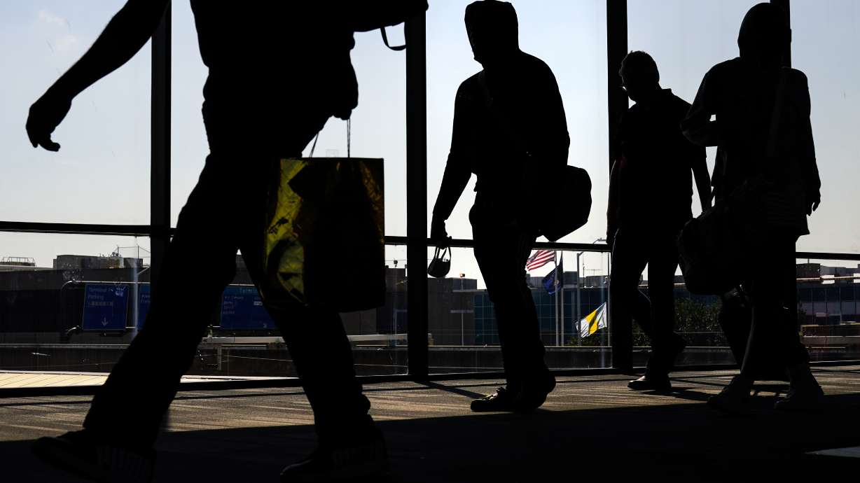 Arriving passengers move toward the baggage claim area at Philadelphia International Airport in Philadelphia on July 1. Travelers will probably pay more for airline tickets or a hotel room around the holidays than they did over last Thanksgiving or Christmas.