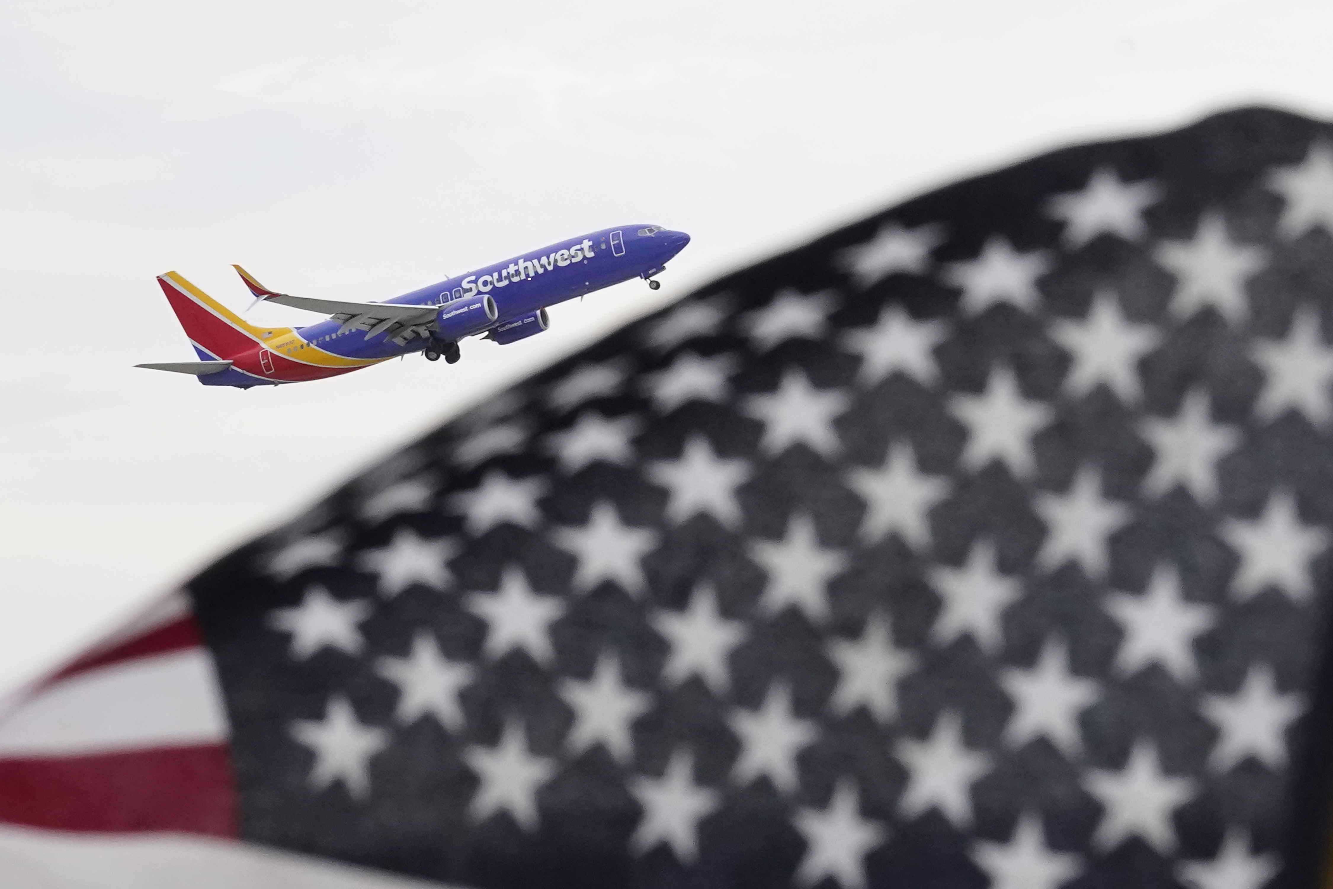 A Southwest Airlines passenger jet takes off at Chicago's Midway International Airport on July 1, in Chicago. Travelers will probably pay more for airline tickets or a hotel room around the holidays than they did over last Thanksgiving or Christmas.