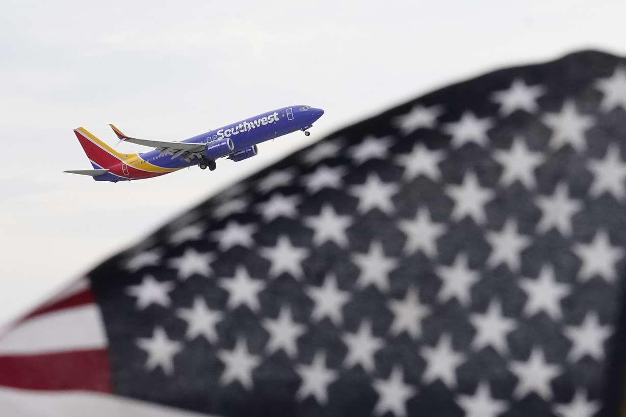 A Southwest Airlines passenger jet takes off at Chicago's Midway International Airport on July 1, in Chicago. Travelers will probably pay more for airline tickets or a hotel room around the holidays than they did over last Thanksgiving or Christmas.