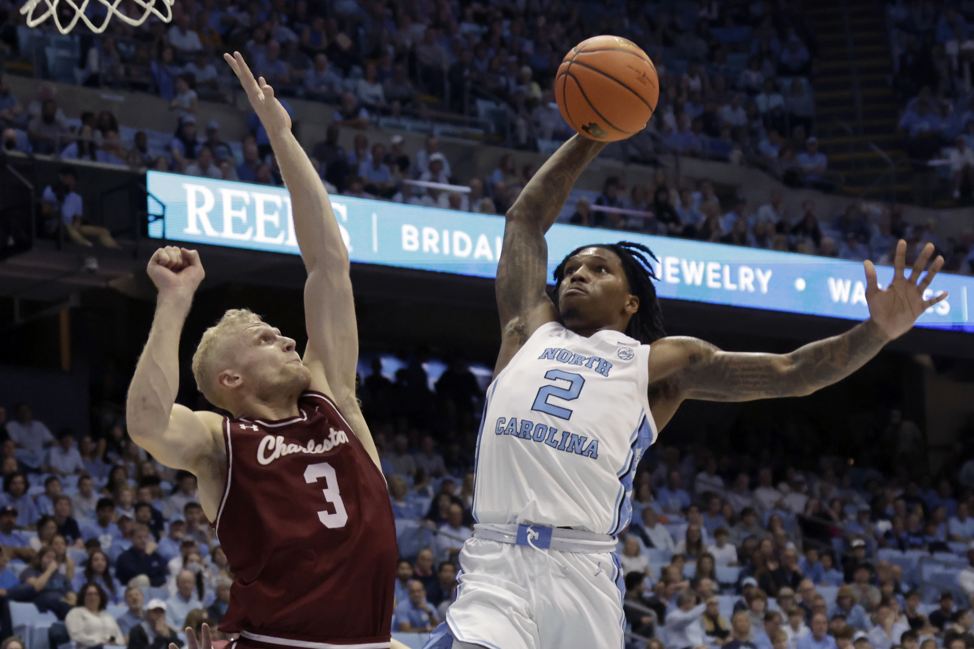 North Carolina guard Caleb Love (2) drives against College of Charleston guard Dalton Bolon (3) during the first half of an NCAA college basketball game Friday, Nov. 11, 2022, in Chapel Hill, N.C. 