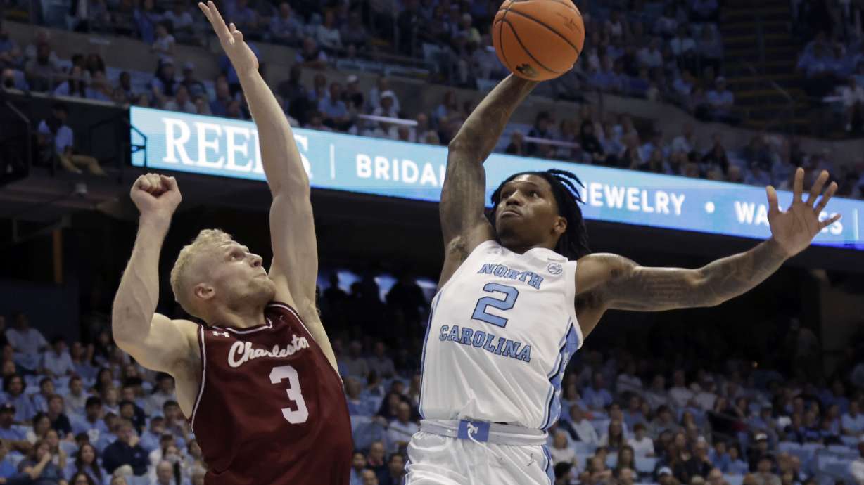 North Carolina guard Caleb Love (2) drives against College of Charleston guard Dalton Bolon (3) during the first half of an NCAA college basketball game Friday, Nov. 11, 2022, in Chapel Hill, N.C.