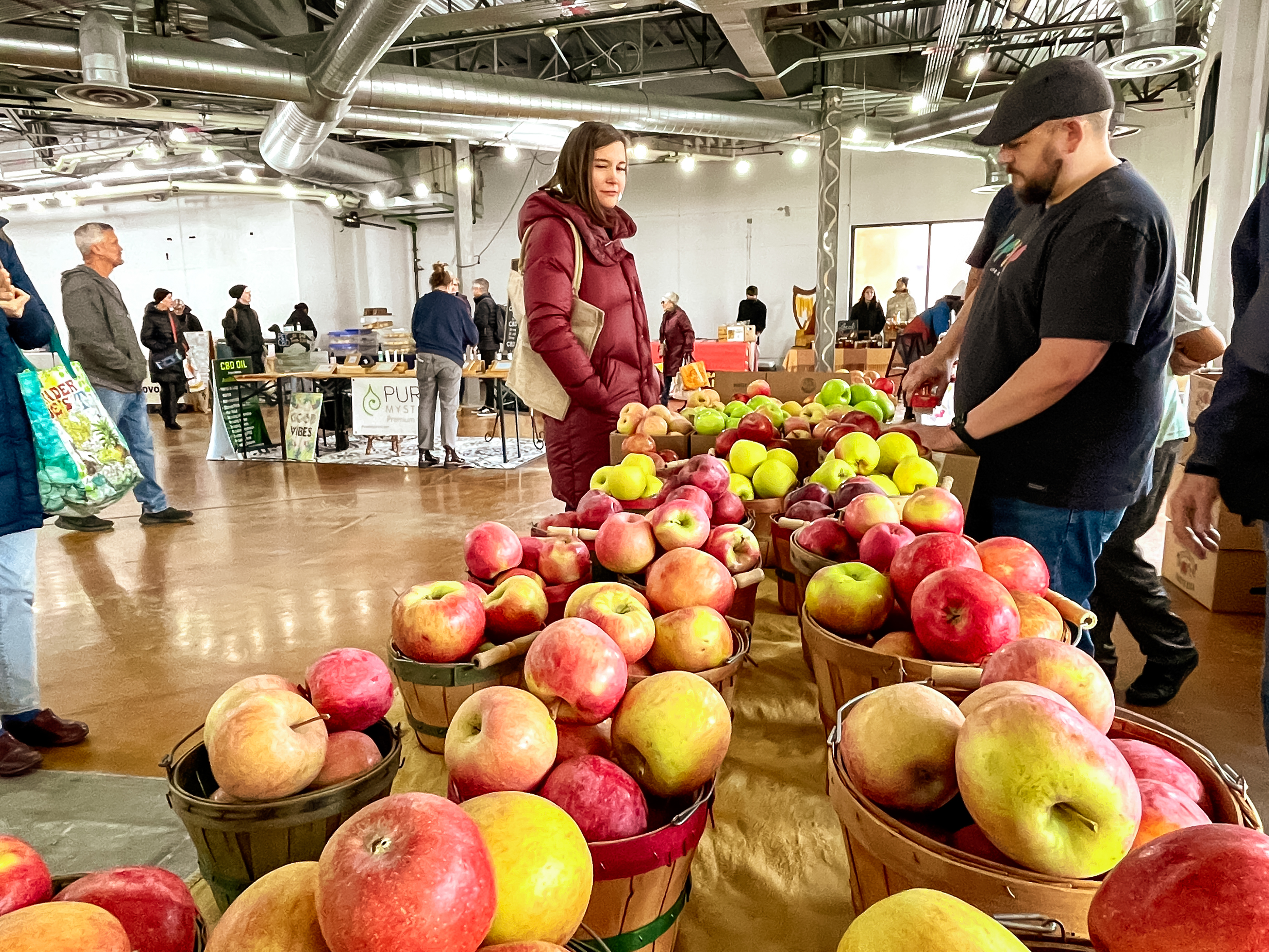 Salt Lake City Mayor Erin Mendenhall checks out a Pyne Farms apple stand at the Salt Lake City Downtown Winter Market on Saturday. Mendenhall attended the market to promote "#SHOPSLC," the city's initiative for local shopping during the holiday season.