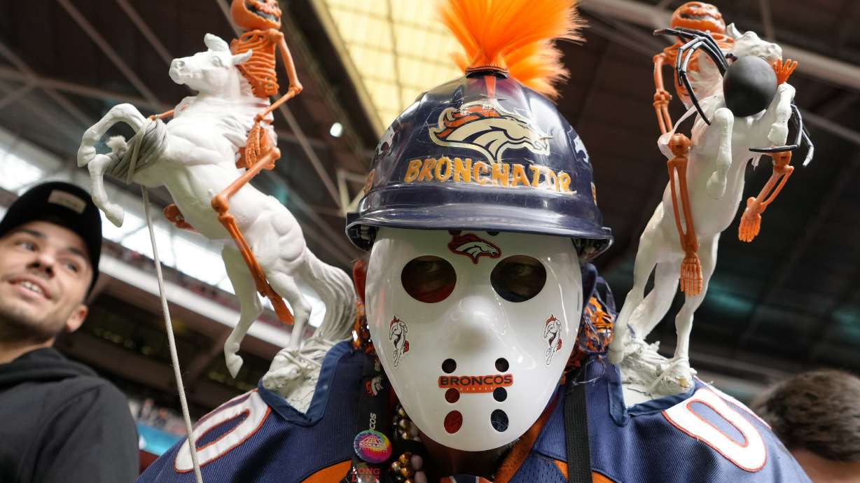 A Denver Broncos supporter cheers before the NFL football game between Denver Broncos and Jacksonville Jaguars at Wembley Stadium London, Sunday, Oct. 30, 2022.