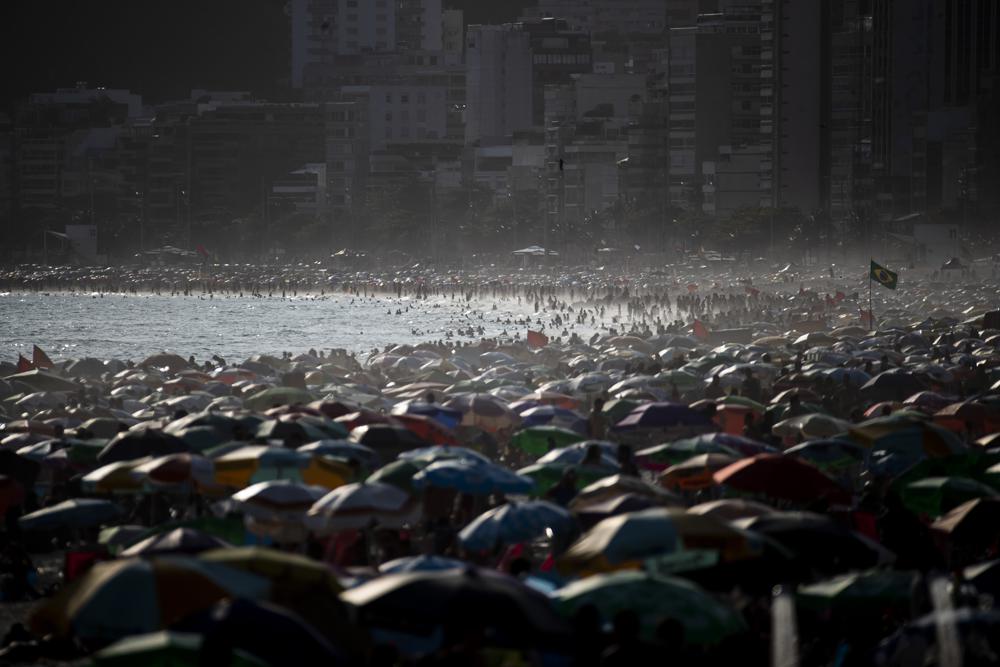 People enjoy the Ipanema beach, in Rio de Janeiro, Brazil, Sunday. The world's population is projected to hit an estimated 8 billion people on Tuesday, according to a United Nations projection.