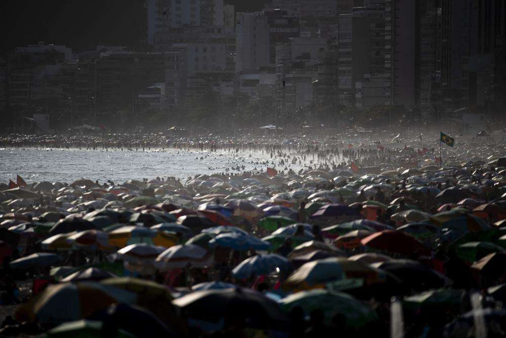 People enjoy the Ipanema beach, in Rio de Janeiro, Brazil, Sunday. The world's population is projected to hit an estimated 8 billion people on Tuesday, according to a United Nations projection.