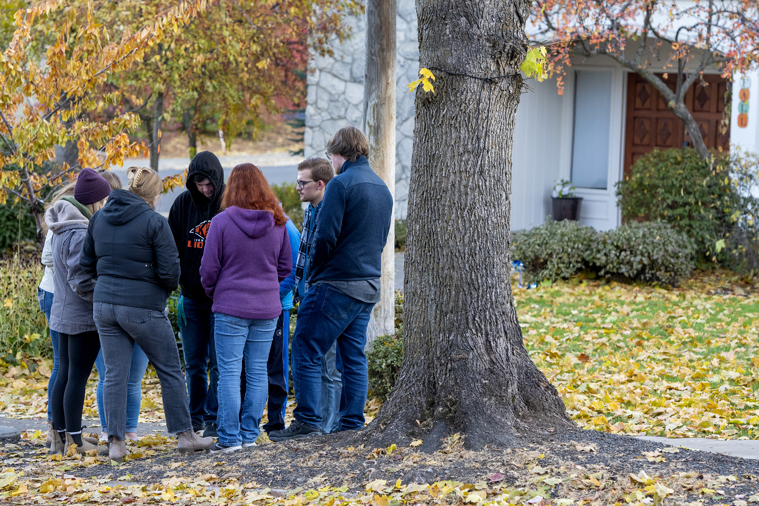 People gather to pray outside of the Pi Beta Phi sorority house at the University of Idaho after four students were found dead at an apartment complex south of campus, including two sorority members, on Monday in Moscow, Idaho.