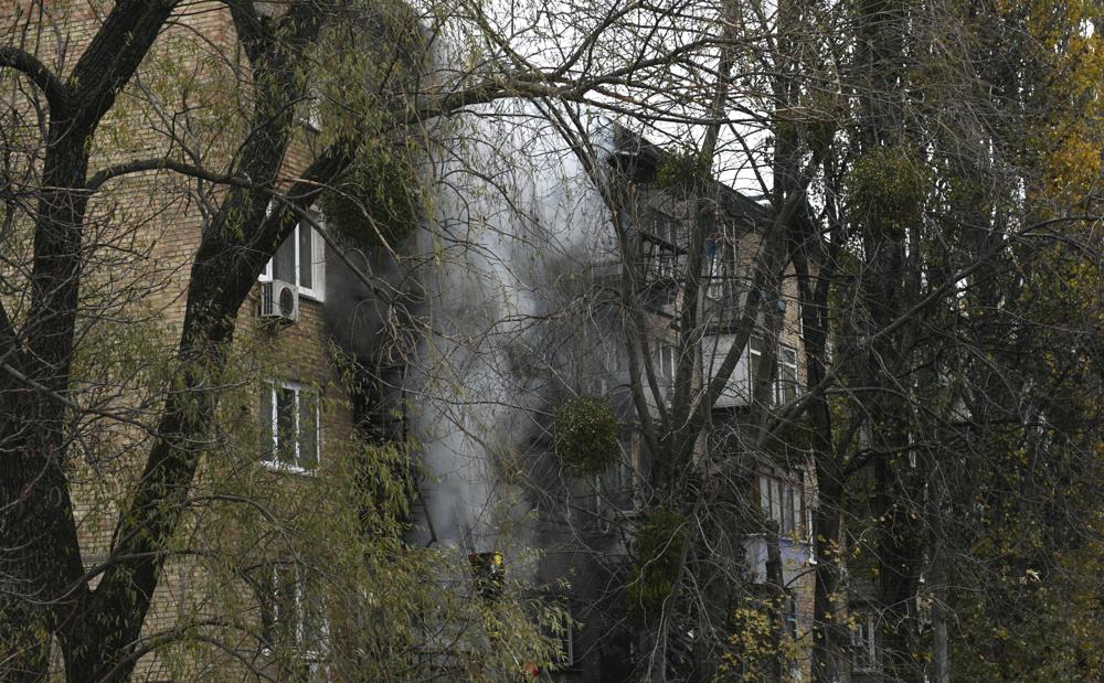 A damaged building seen at the scene of Russian shelling in Kyiv, Ukraine, Tuesday. Strikes hit residential buildings in the heart of Ukraine's capital Tuesday, authorities said. Further south, officials announced probes of alleged Russian abuses in the newly retaken city of Kherson, including torture sites and enforced disappearances and detentions.