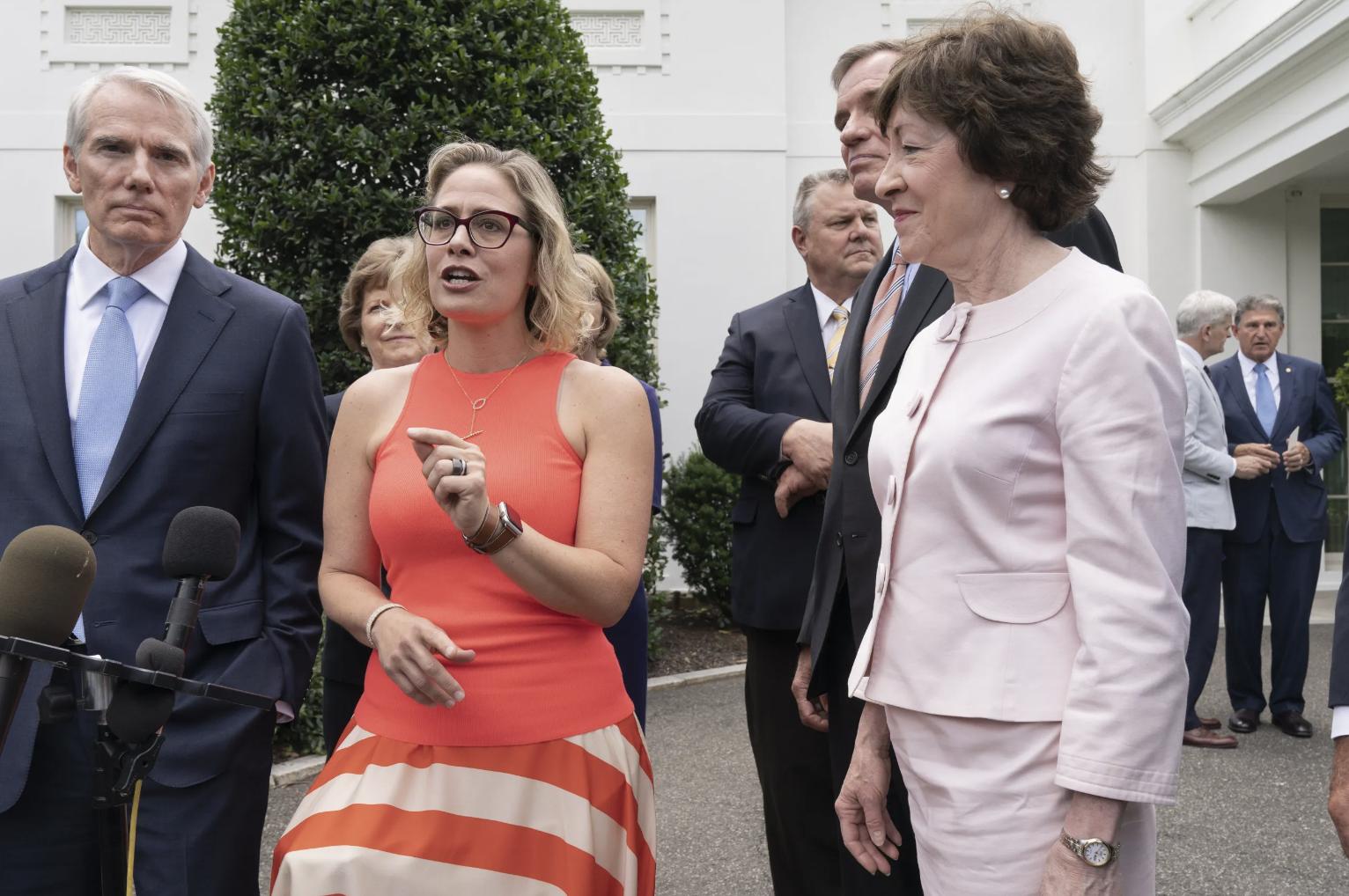 Sen. Kyrsten Sinema, D-Ariz., center, speaks alongside Sen. Rob Portman, R-Ohio and Sen. Susan Collins, R-Maine, June 24, 2021, at the White House in Washington. The trio are among a group of five senators who worked on updating the Respect for Marriage Act.
