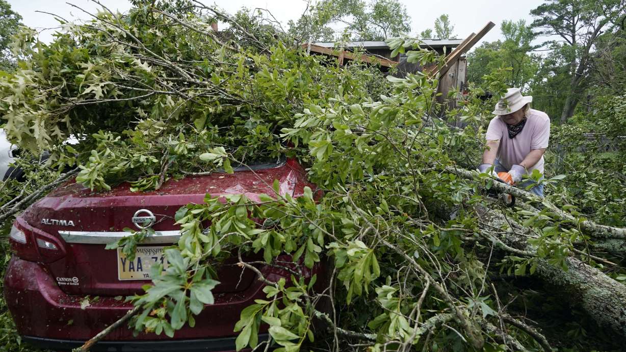 Span McGinty uses his chain saw to cut fallen tree limbs from a tornado-damaged vehicle at his brother's house in Yazoo County, Miss., on May 3, 2021. 90% of counties in the United States experienced a weather-related disaster between 2011-2021, according to a report published on Wednesday. Over 300 million people — 93% of the country’s population — live in those counties.