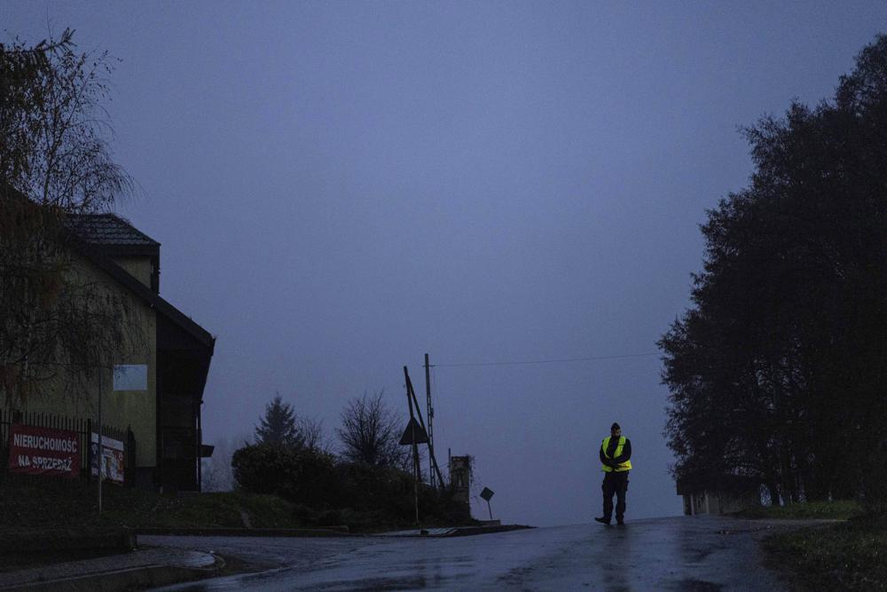 A police officer stands at a checkpoint near the scene of a blast in Przewodow, Poland, Wednesday. Poland said Wednesday that a Russian-made missile fell in the country’s east, though U.S. President Joe Biden said it was “unlikely” it was fired from Russia. 