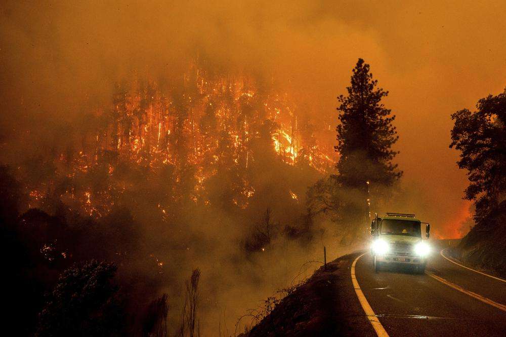 A fire truck drives along California Highway 96 as the McKinney Fire burns in Klamath National Forest, Calif., on July 30. Ninety of counties in the United States experienced a weather-related disaster between 2011-2021, according to a report published on Wednesday. Over 300 million people — 93% of the country’s population — live in those counties.