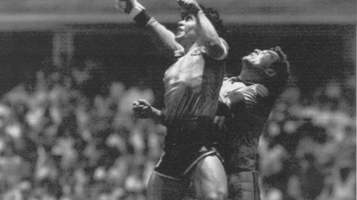 FILE - Argentina's Diego Maradona, left, beats England goalkeeper Peter Shilton to a high ball and scores his first of two goals in a World Cup quarterfinal soccer match, in Mexico City on June 22, 1986. This goal has gone down as the "Hand of God" as Maradona used his left fist to knock a ball past England's Shilton.