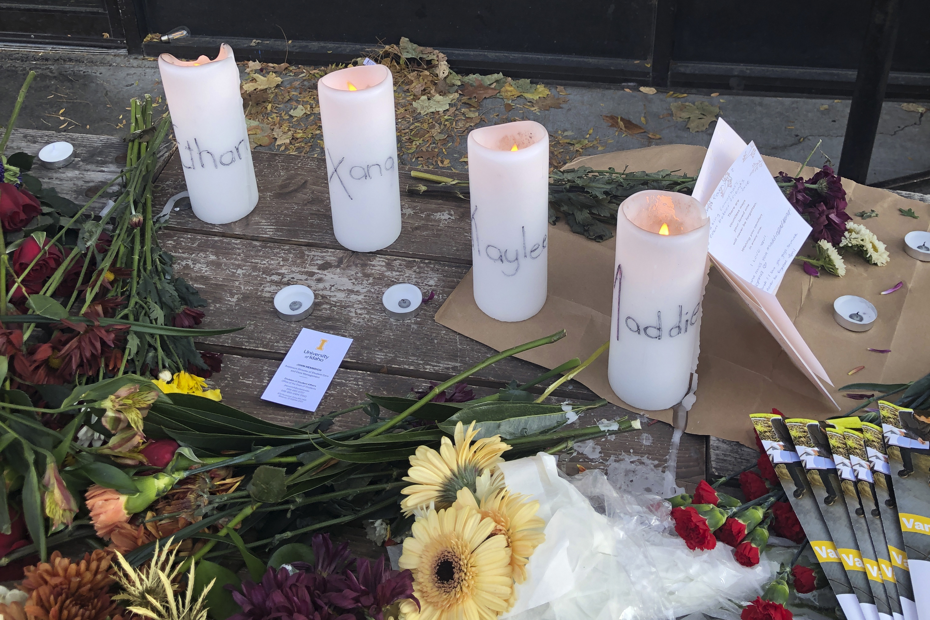 Candles and flowers are left at a makeshift memorial honoring four slain University of Idaho students outside the Mad Greek restaurant in downtown Moscow, Idaho, on Tuesday.